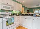 Full size kitchen has Virginia Mist granite counter tops