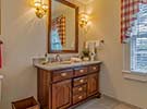 The large Queen Bath has a beautiful cherry vanity with moonstone quartzite top